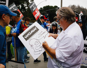The-Simpsons-creator-Matt-Groening-creates-strike-sign-collectibles-for-picketers-Photo-Brittany-Woodside.jpg