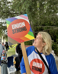 Member-with-a-colorful-Union-Strong-Pride-picket-sign.jpg