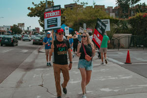 Two-WGA-members-walk-the-picket-line-together-outside-CBS-Television-City-on-September-14th,-2023..jpg