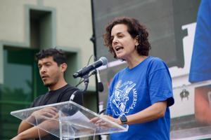 WGA-Negotiating-Committee-member-Danielle-Sanchez-Witzel-addresses-the-crowd-at-the-SAG-AFTRA-L.A.-Solidarity-rally-at-Paramount-on-9-13.jpeg