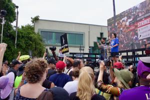 WGA-Negotiating-Committee-member-Danielle-Sanchez-Witzel-speaks-at-the-SAG-AFTRA-L.A.-Solidarity-rally-at-Paramount-on-9-13.jpeg